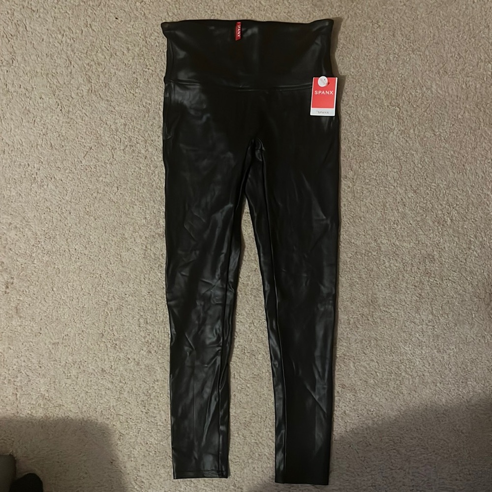 New, never worn black faux leather Spanx leggings. Size large, petite length.